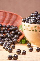 Jabuticaba, Jabuticabas freshly harvested in a bowl and baskets arranged on a straw mat, selective focus.