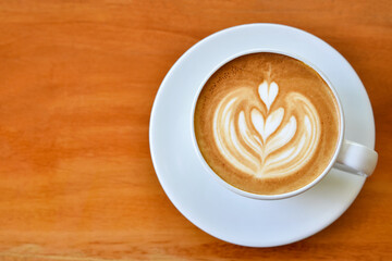 Top view warm coffee cup on brown wooden table.