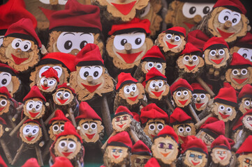Tió de Nadal. A hollow log with a barretina, called Tió, is a Catalan Christmas tradition. The children feed him and on Christmas Day he shits them presents.