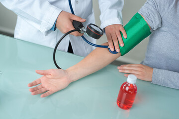 medical worker taking patients blood pressure