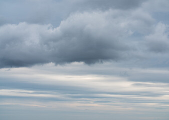 Overcast sky with white, gray and bluish rain clouds.