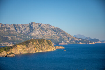 Fototapeta premium Aerial view of Sveti Nikola or St. Nicolas island is in Budva riviera on mountain background, Montenegro
