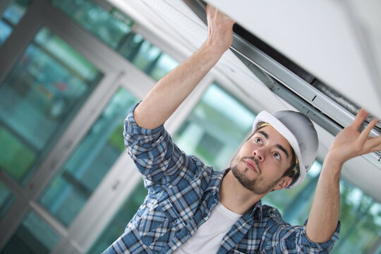 man install suspended ceiling in house