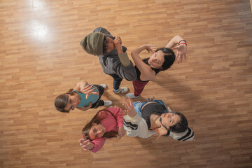 Top view of smiling pretty urban dancers, close-up, indoors.