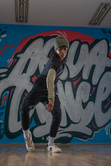 Fototapeta na wymiar Modern rapper dancing in garage. Urban lifestyle, hip hop.