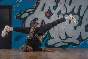 Obraz na płótnie Canvas Modern rapper dancing in garage. Urban lifestyle, hip hop.