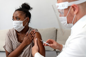 Epidemic outbreak, covid-19 immunization. Professional doctor or nurse giving flu or COVID...
