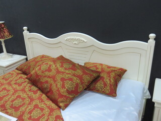 white headboard and orange pillows