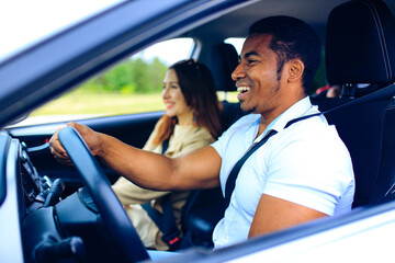 latin man in white t-shirt at the wheel of his new car outdoor summer day