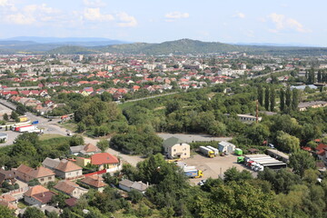 Obraz premium view of a village. Scenic view of the town in the mountains on a cloudy summer day.