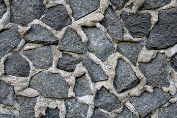 Stones in gray cement textured stucco background