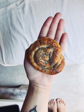 Woman holding a pasty in the palm of her hand