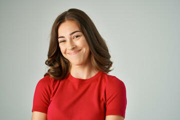 Obraz premium beautiful woman in a red t-shirt hair care light background