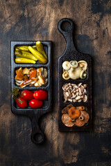 Marinated mushrooms and vegetables on a wooden table