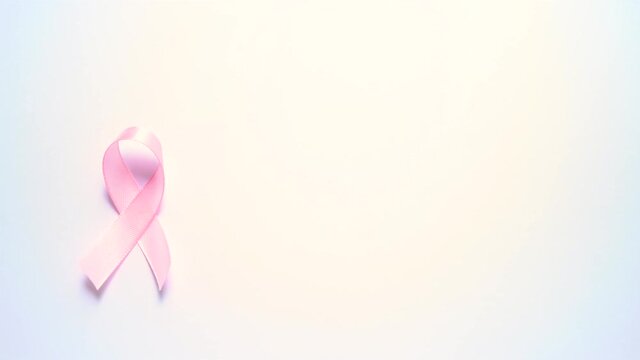 Pink silk ribbon, Symbol of world breast cancer awareness month in october. Female hand puts pink ribbon on white background
