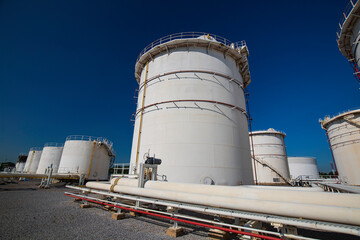 Row of large white tanks for petrol pipeline oil