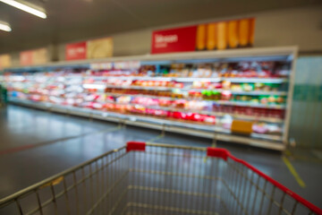 The defocused blur of supermarket buying cart shopping meat.
