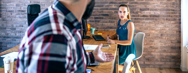 Businesswoman shocked by what her coworker is telling her