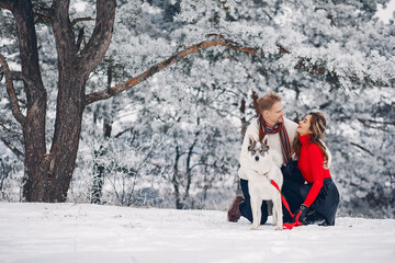 Beautiful couple playing with a dog