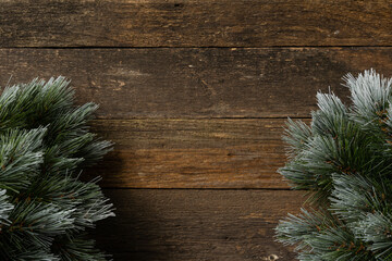 Wooden Christmas background, rustic, old larch boards, curved boards with burrs and cracks, Christmas trees on the sides