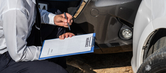 Insurance Agent Inspecting assessed Damaged Car checking and signing on report insurance claim form...