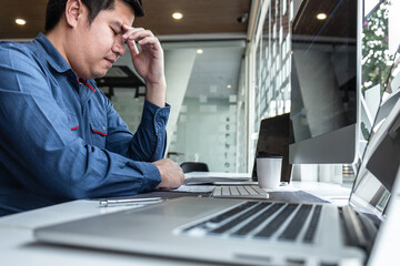 Fototapeta premium Man Programmer stressed and headache project in software development computer in IT company office, Writing codes and data code website and coding database technologies to find solution
