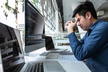 Man Programmer stressed and headache project in software development computer in IT company office,...
