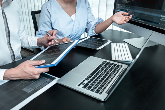 Team of Programmer working in software javascript computer in IT office, Writing codes and data code website and coding database technologies to find solution to problem
