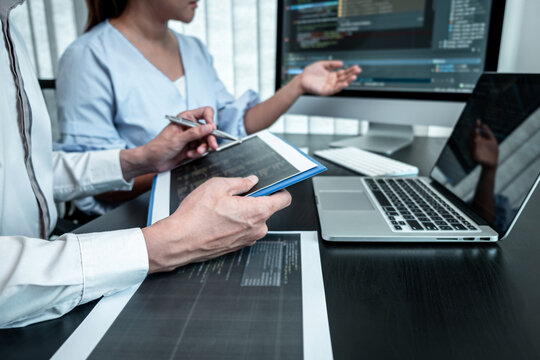 Team of Developer programmer working on coding program software computer in office, Writing website and development database technology
