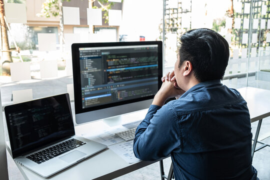 Developer programmer working on project in software development computer in IT company office, Writing codes and data code website and coding database technologies to find solution to problem