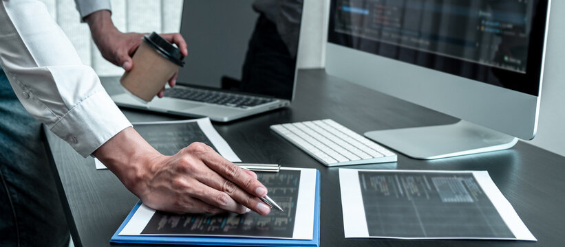 Young Programmer working in software javascript computer in IT office, Writing codes and data code website and coding database technologies to find solution to problem