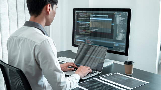 Young Programmer working in software javascript computer in IT office, Writing codes and data code website and coding database technologies to find solution to problem