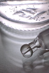 Liquid transparent gel or serum pipette with drops on glass back
