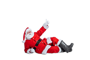 santa claus lies on the floor and shows thumbs up hand gesture on white background isolate. Christmas advertising and sale concept