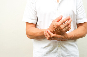 an old man support his arms which pain,numbness,weakness,paralysis concept of Guillain barre syndrome caused by autoimmune disorder