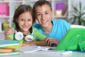 Portrait of brother and sister doing homework together
