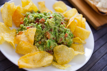 appetizer on a plate. Guacamole with chips