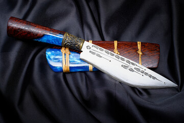 knife custom or Enep in the natural wood scabbard on old table background handmade of Thailand