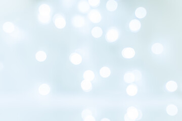 Abstract background blurred ball bokeh white on light blue background. Christmas and holiday symbol. Glare on the water.