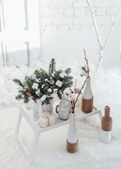 Christmas bouquet of spruce and cotton in a white interior