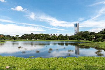 Fototapeta na wymiar Beautiful landscape in La Sabana park with reflection of blue sky in the water.