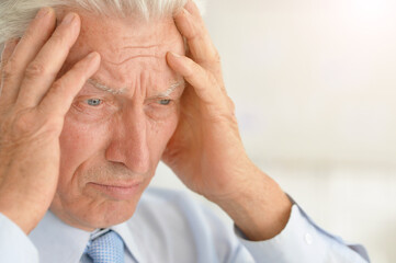 Portrait of sad senior male doctor posing