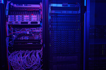 Shot picture of modern dark server room with neon blue