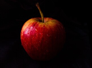 red apple on black background