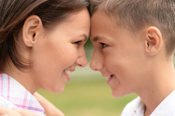 Portrait of beautiful mother with son in park