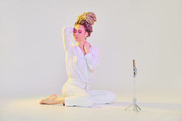 Cheerful woman streaming online using front camera of her mobile