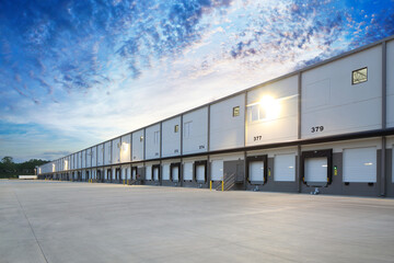 Exterior of modern distribution center warehouse at sunrise - obrazy, fototapety, plakaty