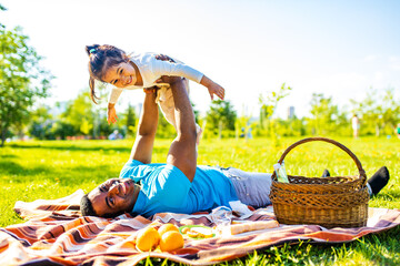 father's day celebration happy afro american man with his cute baby in summer park having fun...