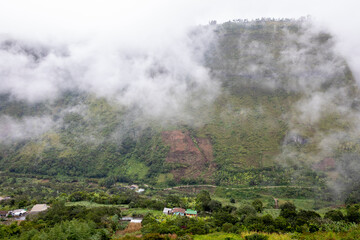 Fototapeta na wymiar Mist and houses in Intag valley, Ecuador