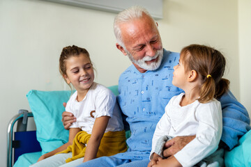 Obraz premium Happy children with senior grandfather laughing and enjoying leisure time together.